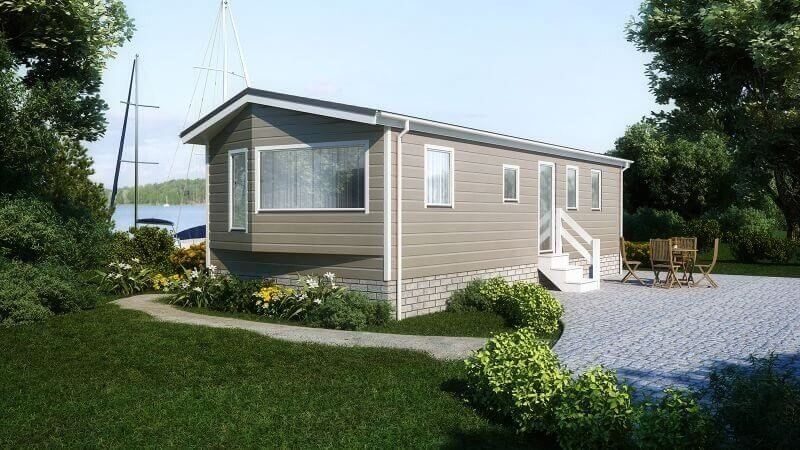 Bungalow am Wasser mit einer Holzoptikfassade in der Farbe olive.